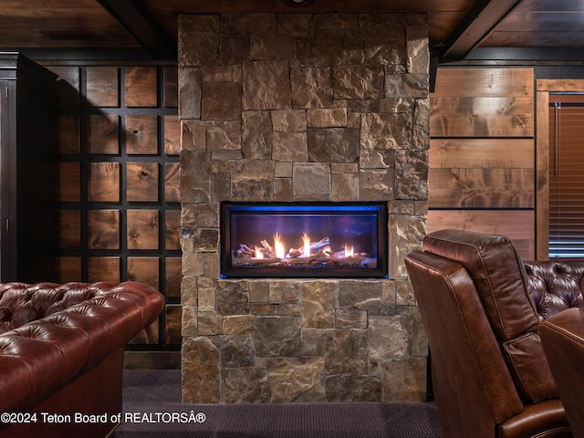 interior details featuring beam ceiling and a fireplace