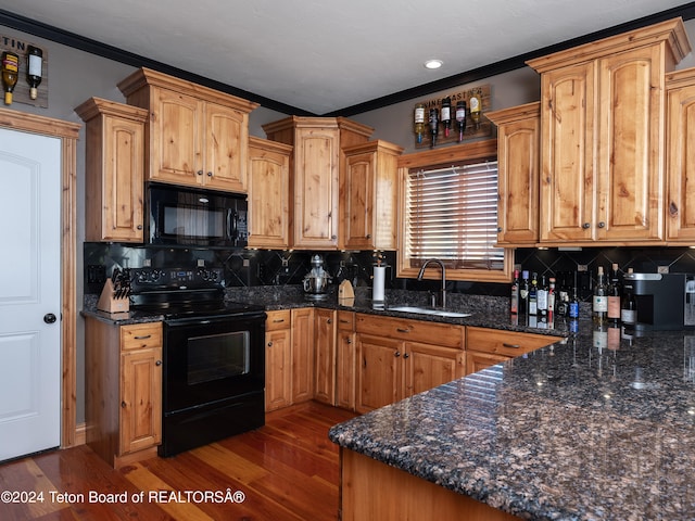 kitchen featuring dark stone counters, dark hardwood / wood-style flooring, sink, and black appliances