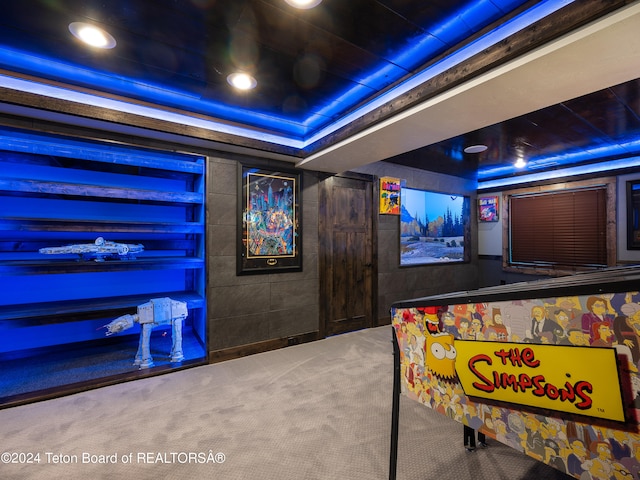 interior space with carpet flooring and a tray ceiling