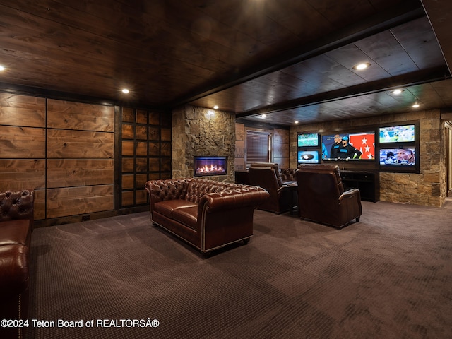 cinema room featuring a fireplace, wooden walls, beamed ceiling, carpet floors, and wood ceiling