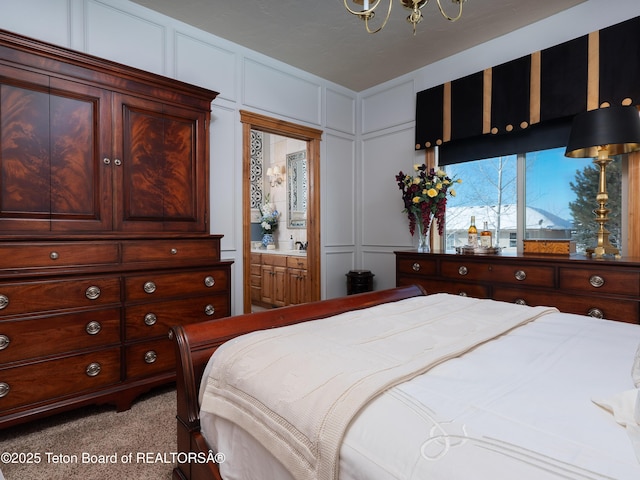 bedroom with light carpet, ensuite bath, and a chandelier