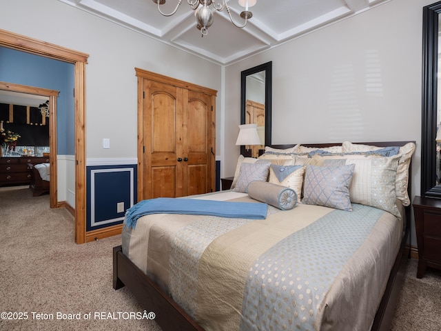 carpeted bedroom with coffered ceiling, a notable chandelier, and beamed ceiling