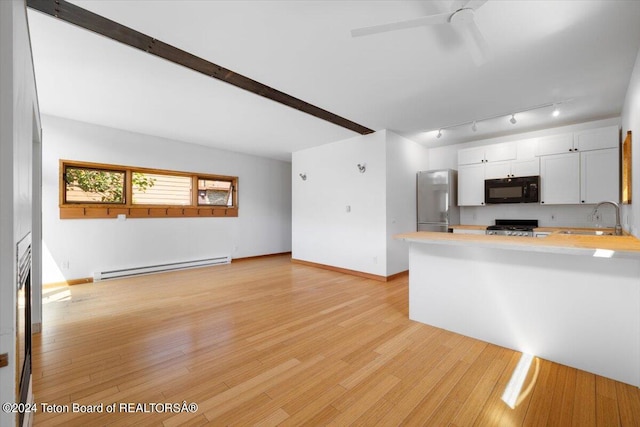 kitchen with white cabinetry, a baseboard heating unit, stainless steel refrigerator, range, and sink