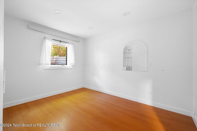 unfurnished room featuring hardwood / wood-style flooring