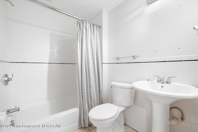 full bathroom featuring sink, tile walls, toilet, and shower / bath combo