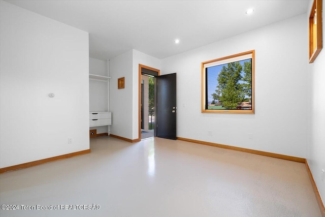 unfurnished bedroom featuring concrete floors