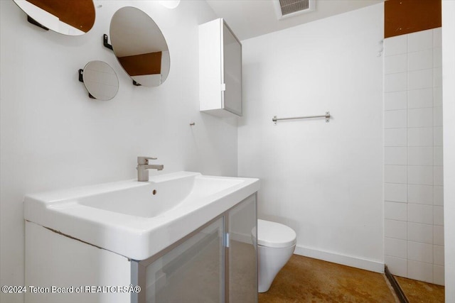 bathroom featuring toilet and vanity