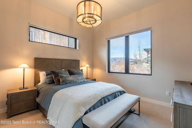 carpeted bedroom with a chandelier