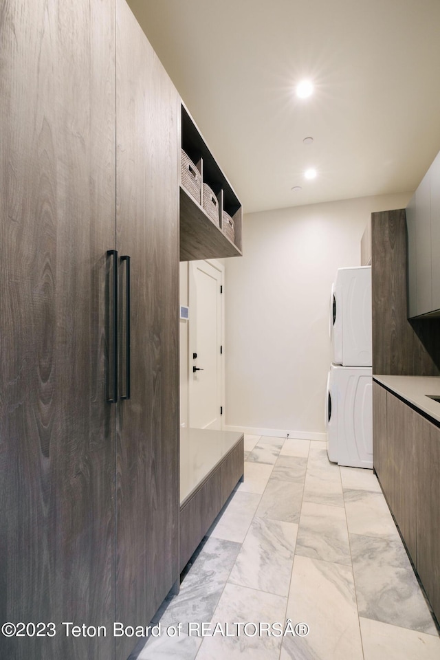 kitchen featuring stacked washing maching and dryer