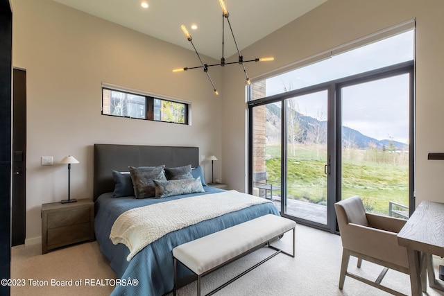 carpeted bedroom with access to outside, vaulted ceiling, and a mountain view