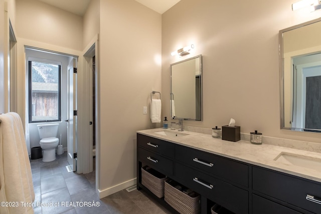 bathroom featuring vanity and toilet