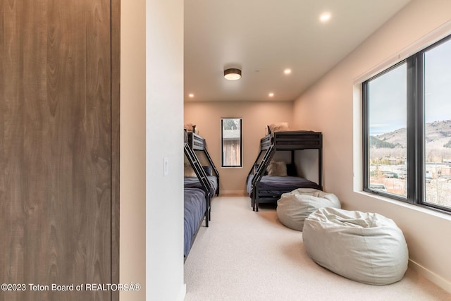 bedroom with carpet floors and a mountain view