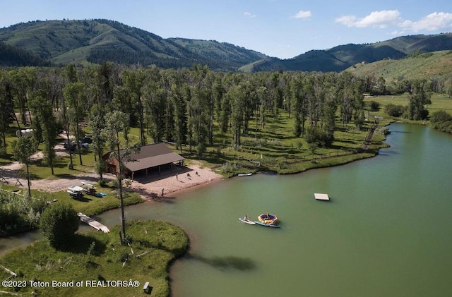 drone / aerial view featuring a water and mountain view