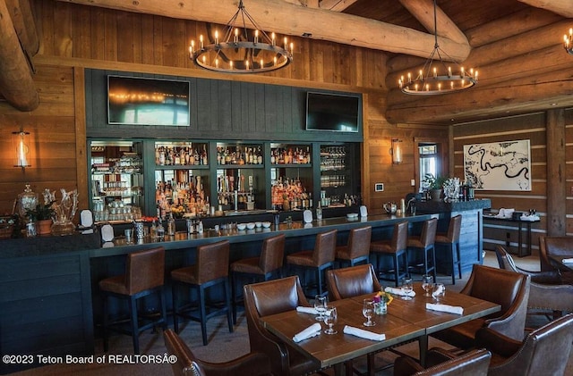 bar featuring wooden walls, wood ceiling, and hanging light fixtures