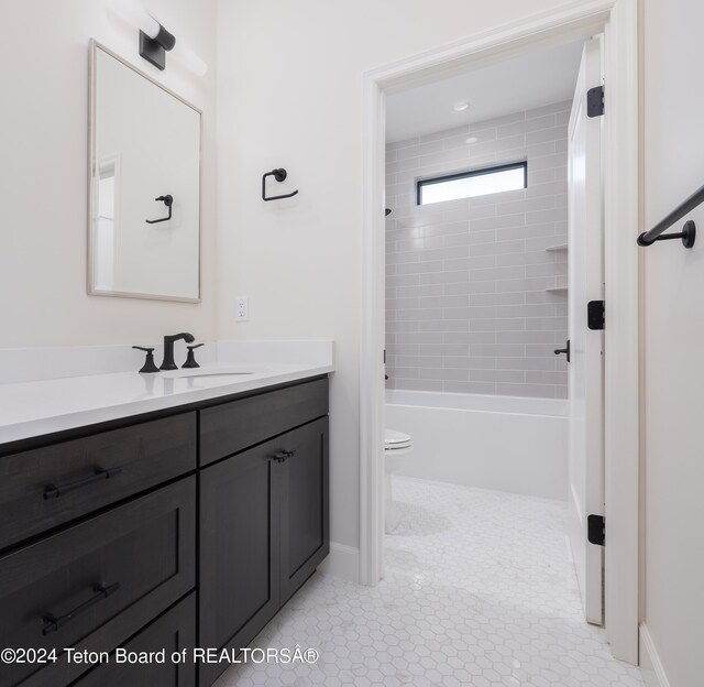 full bathroom with vanity, toilet, tiled shower / bath, and tile patterned flooring