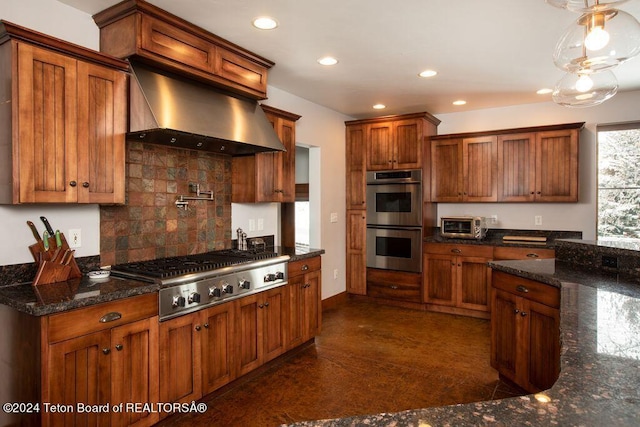 kitchen with recessed lighting, stainless steel appliances, wall chimney range hood, brown cabinets, and decorative backsplash