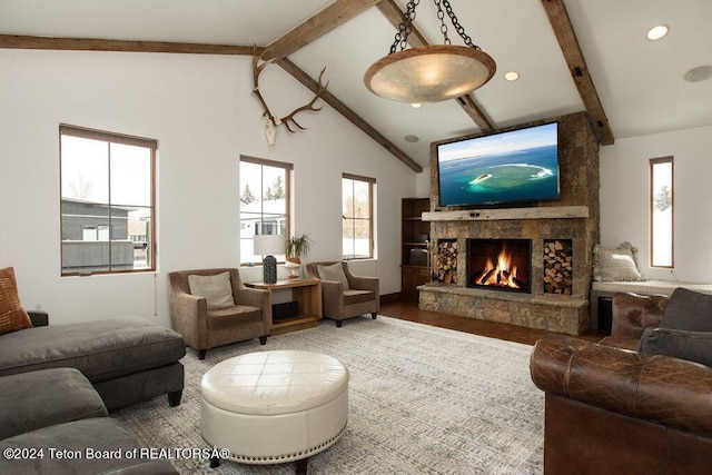 living room featuring recessed lighting, a stone fireplace, wood finished floors, high vaulted ceiling, and beamed ceiling