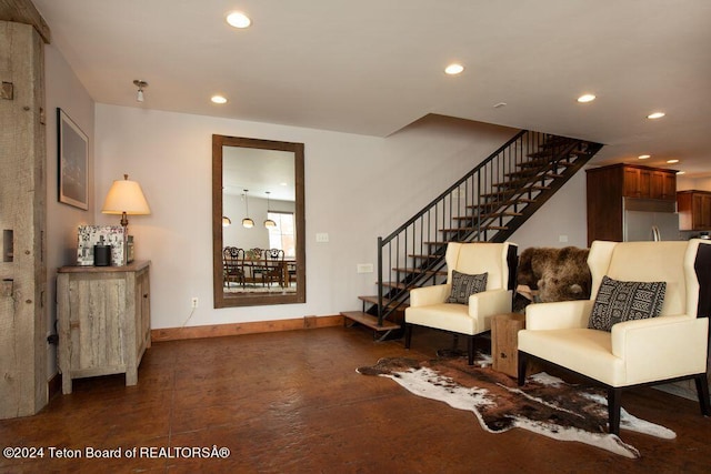 sitting room featuring baseboards, stairway, and recessed lighting