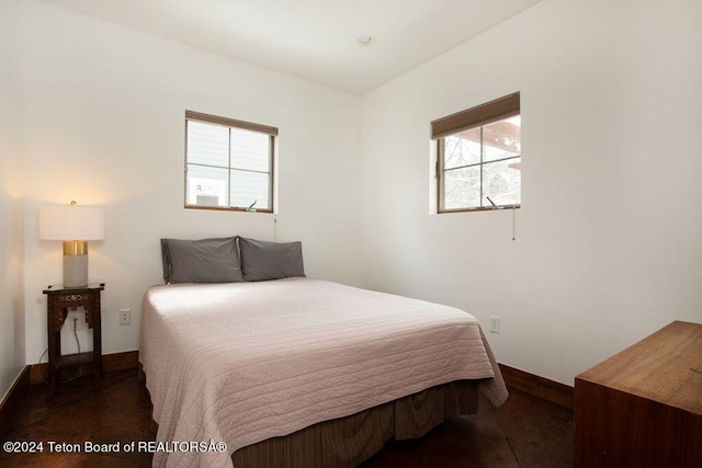 bedroom featuring baseboards and wood finished floors