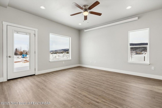 unfurnished room featuring ceiling fan and light wood-type flooring