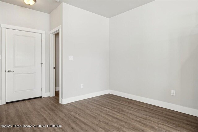 empty room featuring dark hardwood / wood-style flooring