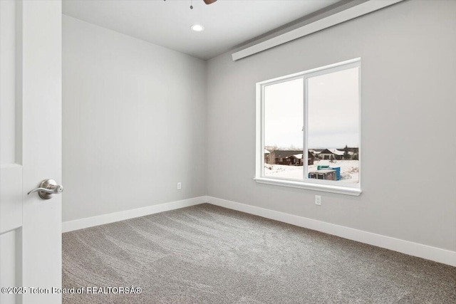 empty room with carpet and ceiling fan