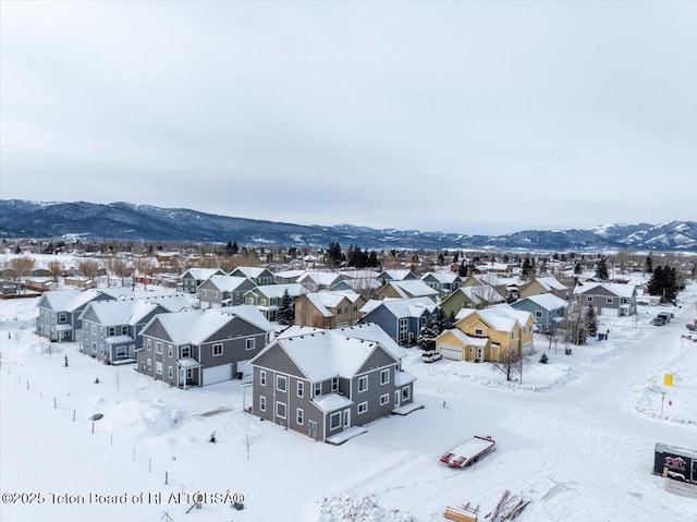 snowy aerial view featuring a mountain view