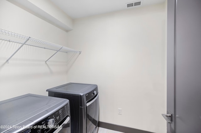 washroom featuring washing machine and dryer