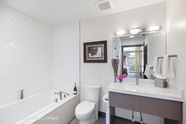 bathroom featuring vanity, toilet, and a bathing tub