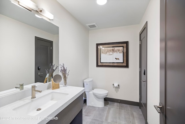 bathroom featuring tile patterned floors, vanity, and toilet