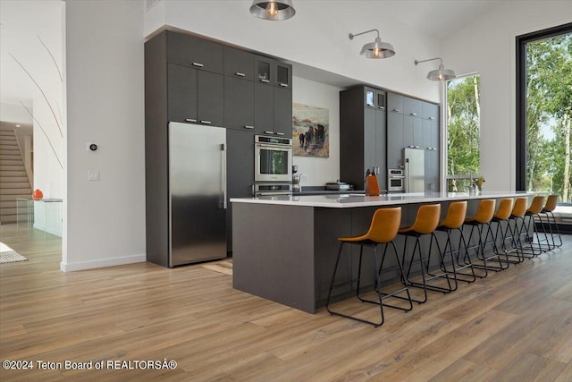 kitchen featuring appliances with stainless steel finishes, light hardwood / wood-style flooring, and a kitchen island