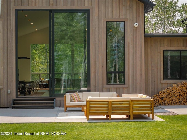 view of exterior entry featuring an outdoor hangout area and a patio area