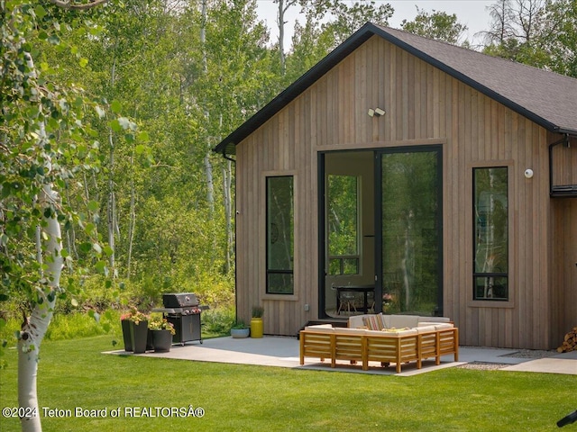 view of outbuilding featuring an outdoor living space and a lawn