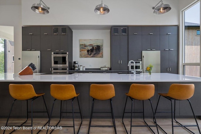 kitchen featuring sink, a kitchen island, hardwood / wood-style floors, and stainless steel appliances