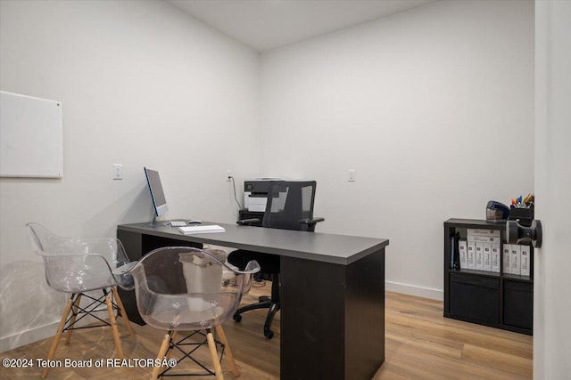 office with light hardwood / wood-style flooring