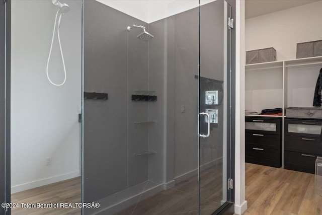 bathroom with walk in shower and hardwood / wood-style floors