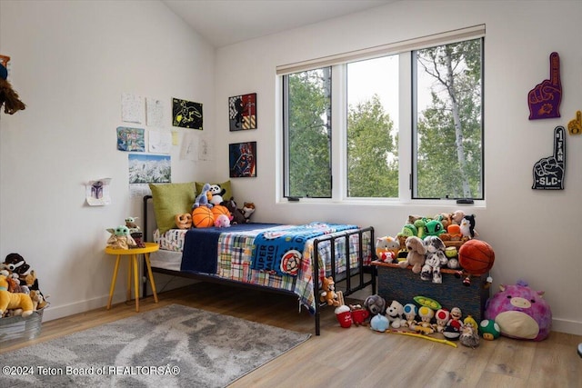 bedroom with hardwood / wood-style flooring