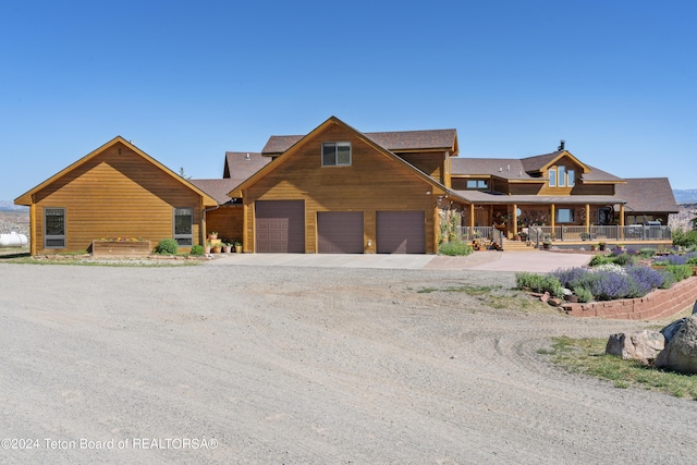 14 Table Top Dr, Dubois, WY 82513 - view of front of house featuring driveway and covered porch