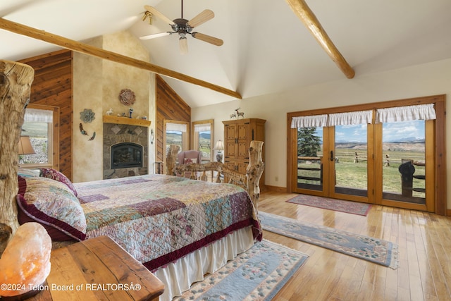 14 Table Top Dr, Dubois, WY 82513 - bedroom with high vaulted ceiling, multiple windows, access to exterior, beamed ceiling, and wooden walls