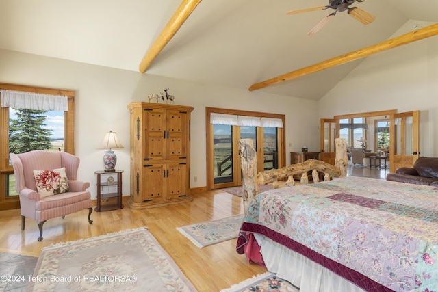 14 Table Top Dr, Dubois, WY 82513 - bedroom with access to outside, multiple windows, wood finished floors, beam ceiling, and high vaulted ceiling