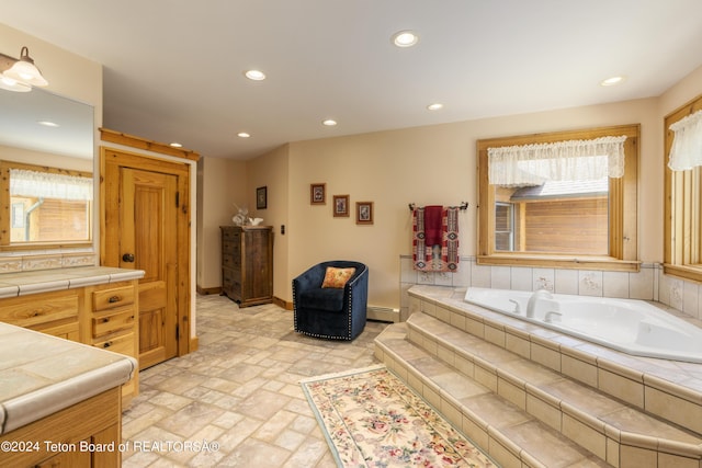 14 Table Top Dr, Dubois, WY 82513 - bathroom with a garden tub, recessed lighting, a baseboard radiator, vanity, and baseboards