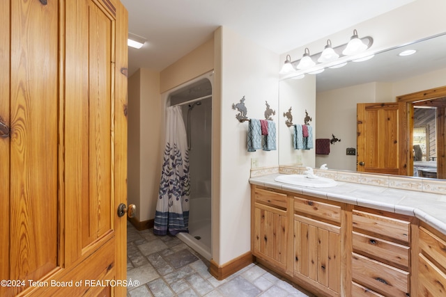 14 Table Top Dr, Dubois, WY 82513 - full bath with vanity, baseboards, a shower with curtain, stone finish flooring, and recessed lighting