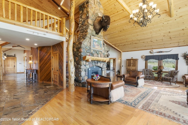 14 Table Top Dr, Dubois, WY 82513 - living room with high vaulted ceiling, wooden ceiling with exposed beams, a chandelier, wood finished floors, and a fireplace