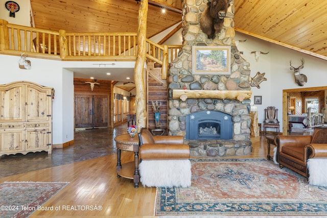 14 Table Top Dr, Dubois, WY 82513 - living area featuring wood ceiling, wood finished floors, stairs, high vaulted ceiling, and a stone fireplace