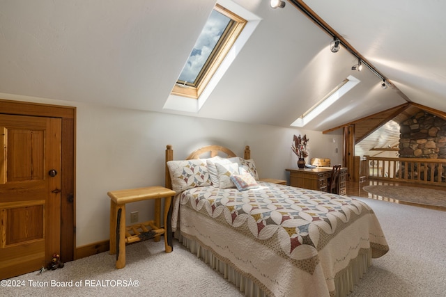 14 Table Top Dr, Dubois, WY 82513 - bedroom with track lighting, light carpet, lofted ceiling, and a skylight