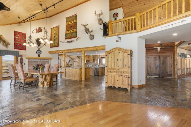 14 Table Top Dr, Dubois, WY 82513 - dining area featuring a high ceiling, wooden ceiling, a chandelier, track lighting, and wood finished floors