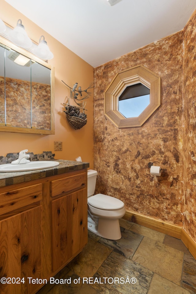 14 Table Top Dr, Dubois, WY 82513 - bathroom with vanity, toilet, and baseboards