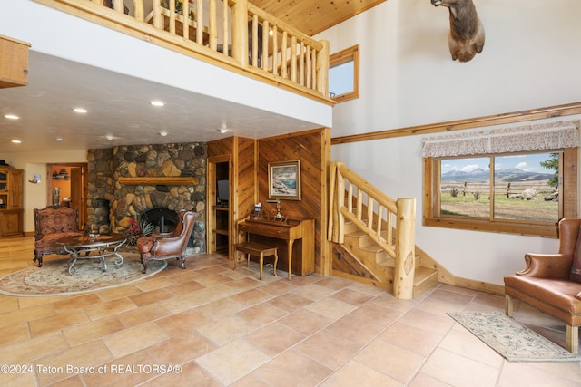 14 Table Top Dr, Dubois, WY 82513 - living area with a towering ceiling, a fireplace, stairs, recessed lighting, and baseboards