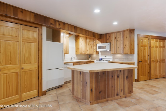 14 Table Top Dr, Dubois, WY 82513 - kitchen featuring white appliances, light countertops, recessed lighting, tasteful backsplash, and a center island