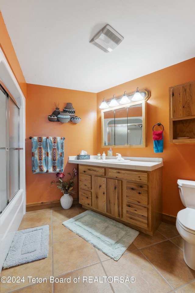 14 Table Top Dr, Dubois, WY 82513 - full bath with toilet, vanity, tile patterned floors, and baseboards